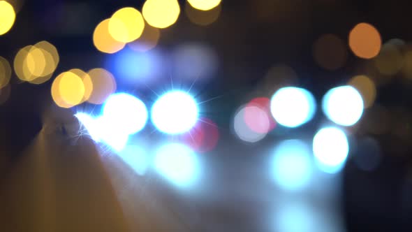 Cars Drive on a Busy Road in a City at Night - Unfocus