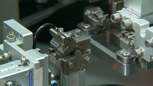 Close up on industrial production line for small parts, robotic arms