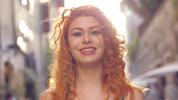 femininity, beauty - young attractive woman walks towards the camera smiling