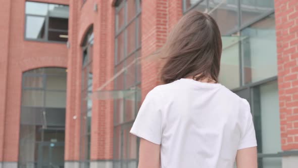 Close up of Young Woman Walking on Street, Back View