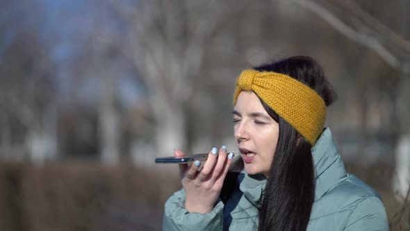 Young Female Student Talks on the Phone