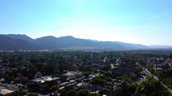 Drone shot of the mountains and city of Solvang Ca.