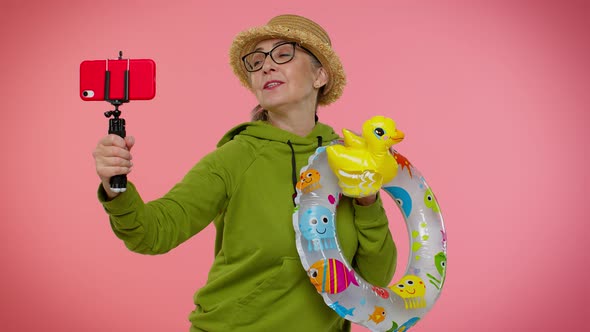 Mature Grandmother Traveler Blogger in Sunglasses Taking Selfie on Mobile Phone Video Call Online