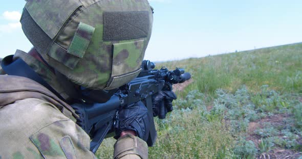 Russian Army Soldier Holds a Machine Gun Forward