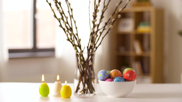 Easter Eggs, Willow and Candles Burning at Home