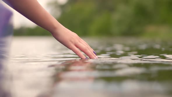 Hands Playing And Touching Water In Slow Motion. Woman Having Fun On Holiday Vacation Weekend Trip.