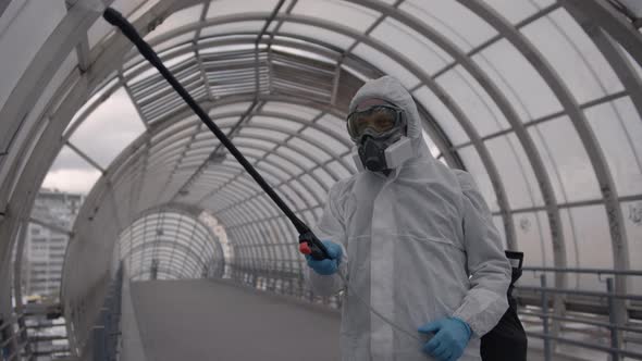 Worker Disinfects the Walls of the Bridge From Covid-19