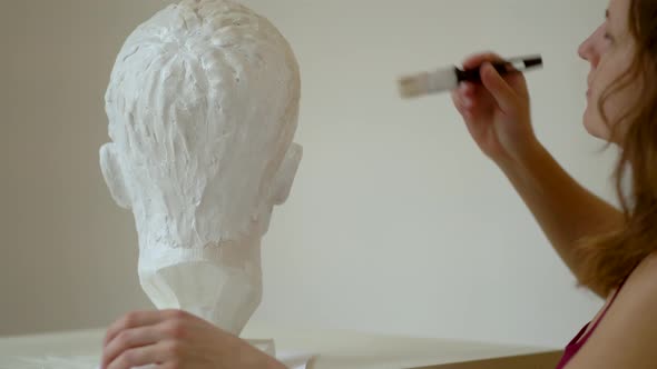 Sculptor Repairing Gypsum Sculpture of Man's Head