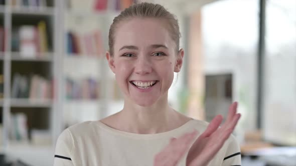 Portrait of Cheerful Young Woman Clapping