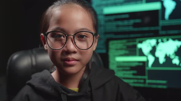 Asian Young Girl Hacker Takes Off Her Hood And Pose With Multiple Computer Screens