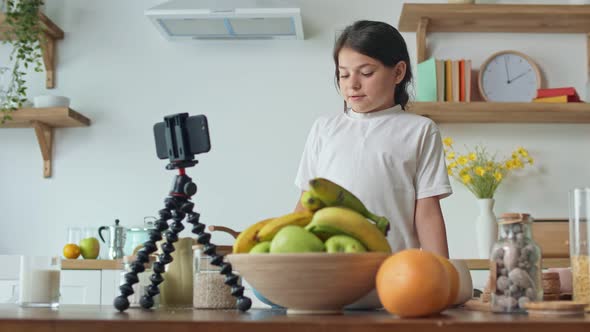 A Girl Vlogger Records Video Content for a Culinary Blog. Webinar Concept