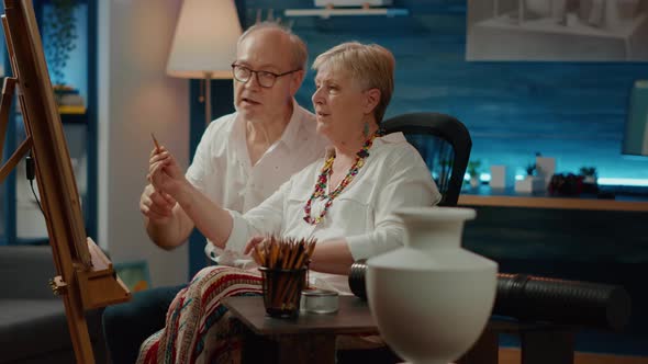 Senior Man and Woman Looking at Vase Design to Draw Masterpiece