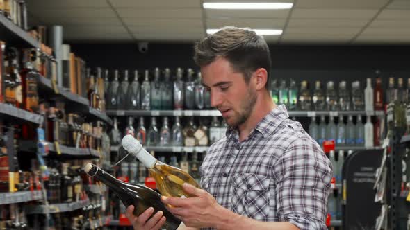 Handsome Young Man Smiling To the Camera Shopping for Wine