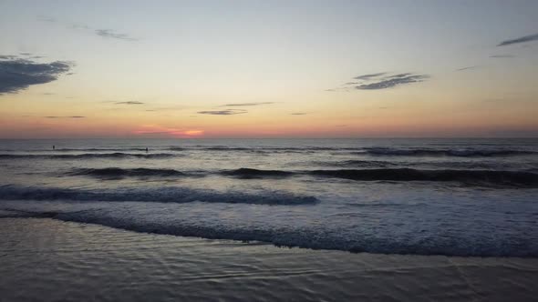 Sunrise Drone at Beach with Surfers