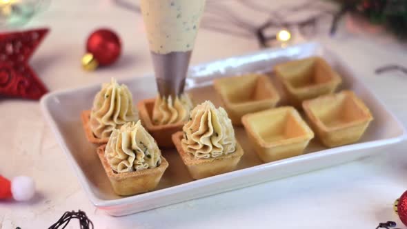 Making Christmas appetizers with savory seafood mousse