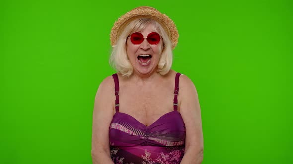 Amazed Senior Pensioner Woman Tourist in Swimsuit Shocked By Sudden Victory Saying Wow on Chroma Key