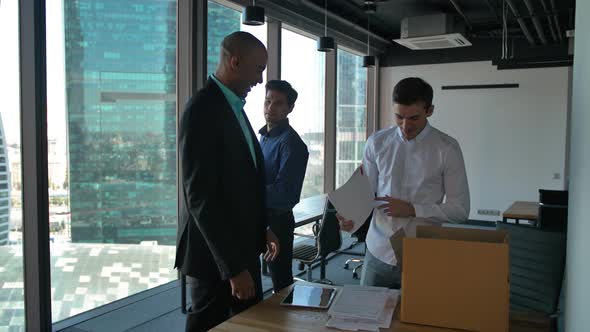 Business People Unpacking Items Inside of New Modern Office