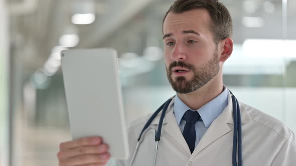 Portrait of Male Doctor Doing Video Call on Digital Tablet 
