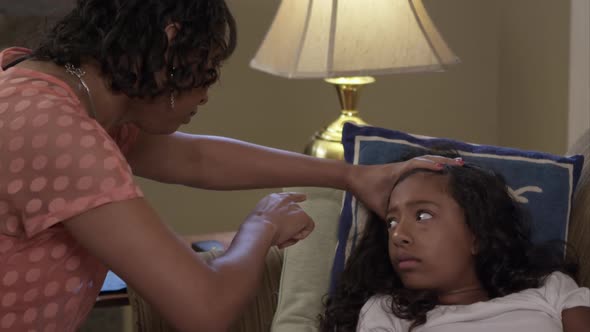 Mother checks young daughter's vitals.