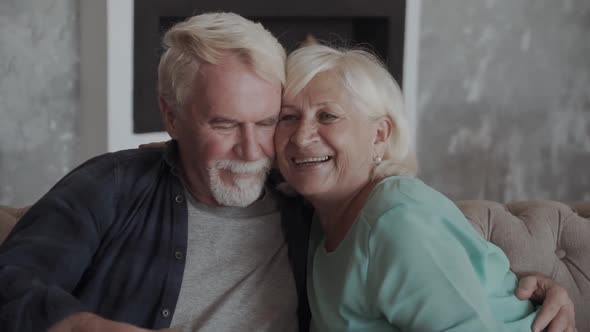Happy Smiling Senior Couple Embracing Together at Home