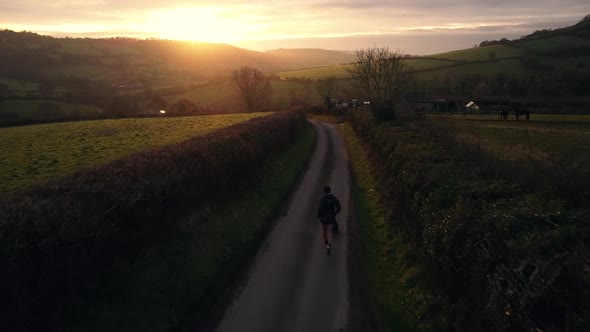 Dusk Dawn Aerial Drone Countryside Runner With Dog Road Sunrise Sunset 1