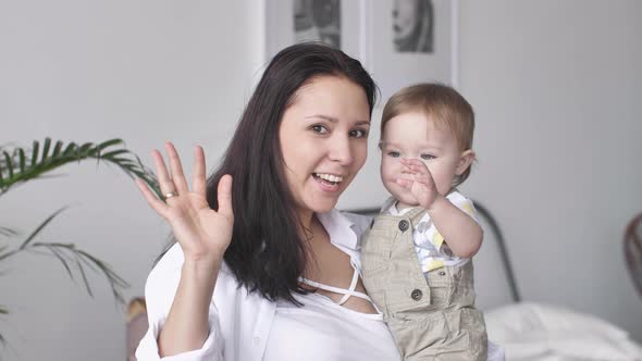 Portrait of Happy Family Young Mother and Toddler Baby Boy Looking at Camera