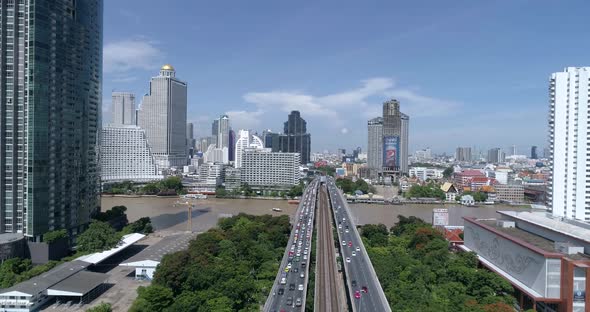 Backwards flight along the busy traffic on the Saphan Taksin Bridge in Bangkok, Thailand,