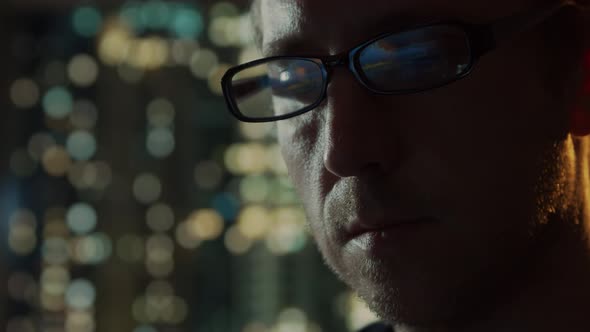 Close-up portrait of a young man working at the computer.