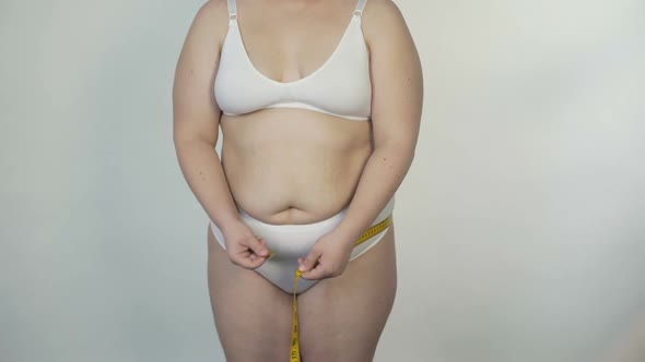 Plump Woman Taking Body Measurements, Overweight Lady, Dieting and Motivation