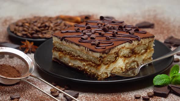 Portion of Traditional Italian Tiramisu dessert and coffee beans