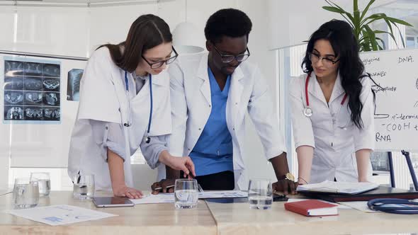 Team of Multi National Doctors Discussing Result of Blood Analysis 