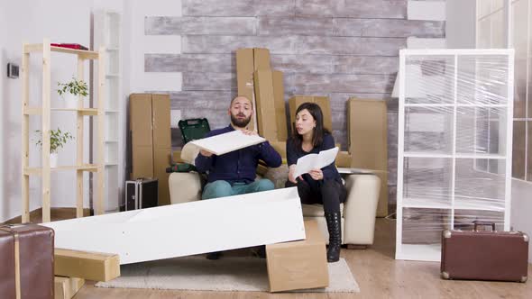 Zoom in Shot of Young Couple Assembing Furniture