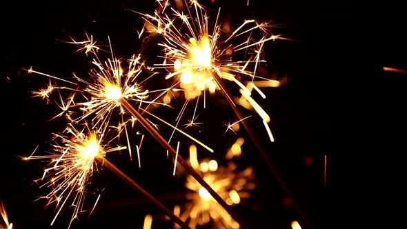 Close up several firework sparklers over black