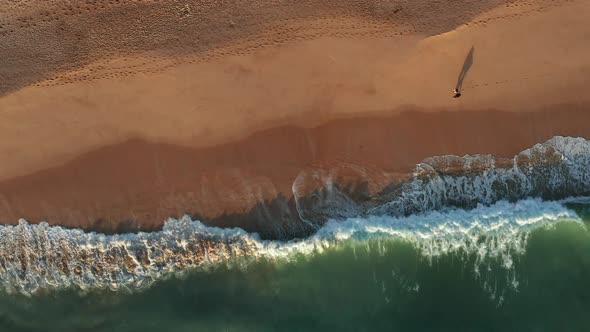 Aerial view of Praia dos Salgados with two people walking at the beach