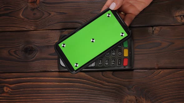 Closeup a Smartphone with Green Screen Template with an NFC Payment Technology