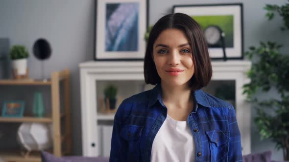 Slow Motion Portrait of Pretty Girl Looking at Camera with Happy Smile at Home