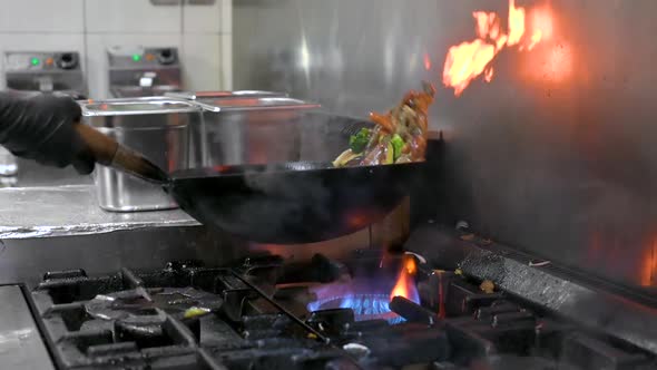 Slow Motion of Chef Cookin Wokg in the Kitchen