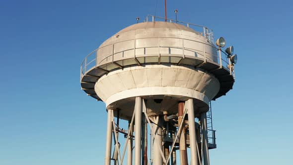 Water tower - elevated liquid storage tank. Metal reservoir for compressed gases hazardous chemicals