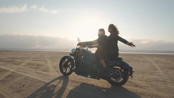 Guy with a Girl on a Motorcycle in the Desert