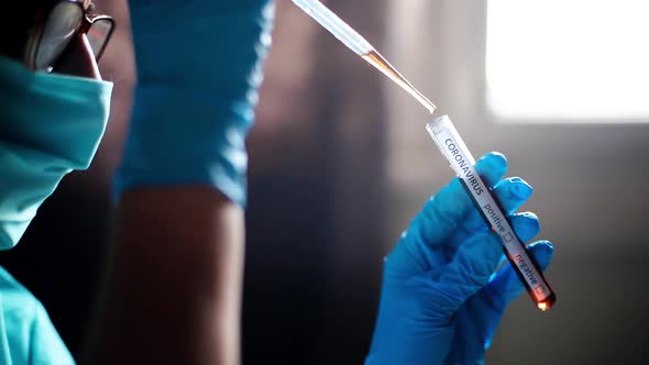 Doctor taking samples from coronavirus COVID-19 test tube