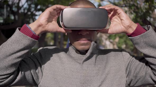 Young Man Wearing Virtual Reality Headset Outdoor