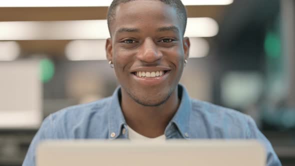 African American Man Smiling at Camera at Work