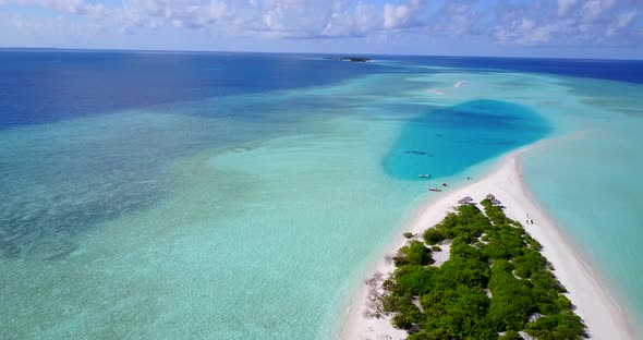 Beautiful fly over travel shot of a white paradise beach and blue water background in high resolution