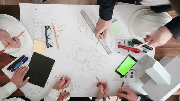 Large Work Table on Which Are Glasses, Phone, Markers, Pencils, Rulers. Hands of Designers Make