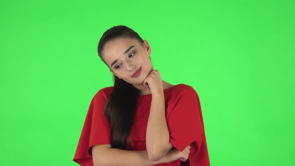 Portrait of Pretty Young Woman Is Daydreaming and Smiling Looking Up. Green Screen