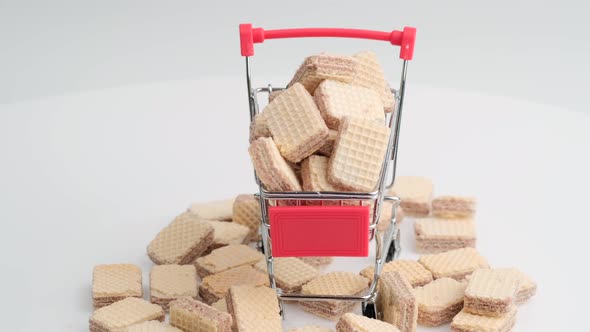 Spinning Pile of Square Wafer Biscuits and Shopping Cart