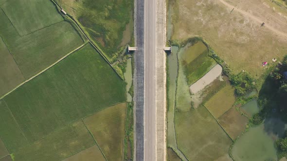 Aerial view of a road among the fields in Sapahar, Rajshahi, Bangladesh.