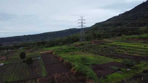 The drone's forward aerial motion captures the path of electricity in cloudy weather