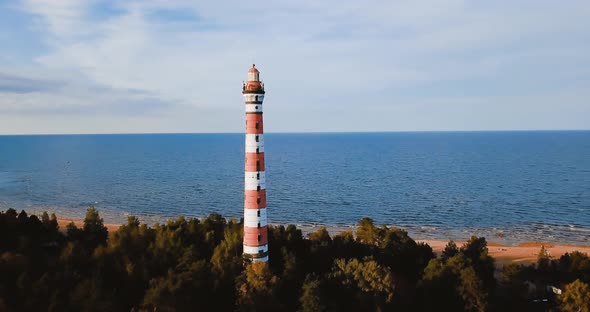 Old Active Lighthouse. Gloomy Sky and Cold Blue Atmosphere. Beach, North Misty Sea in Vintage