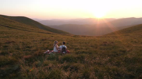 Couple relaxing on a hill